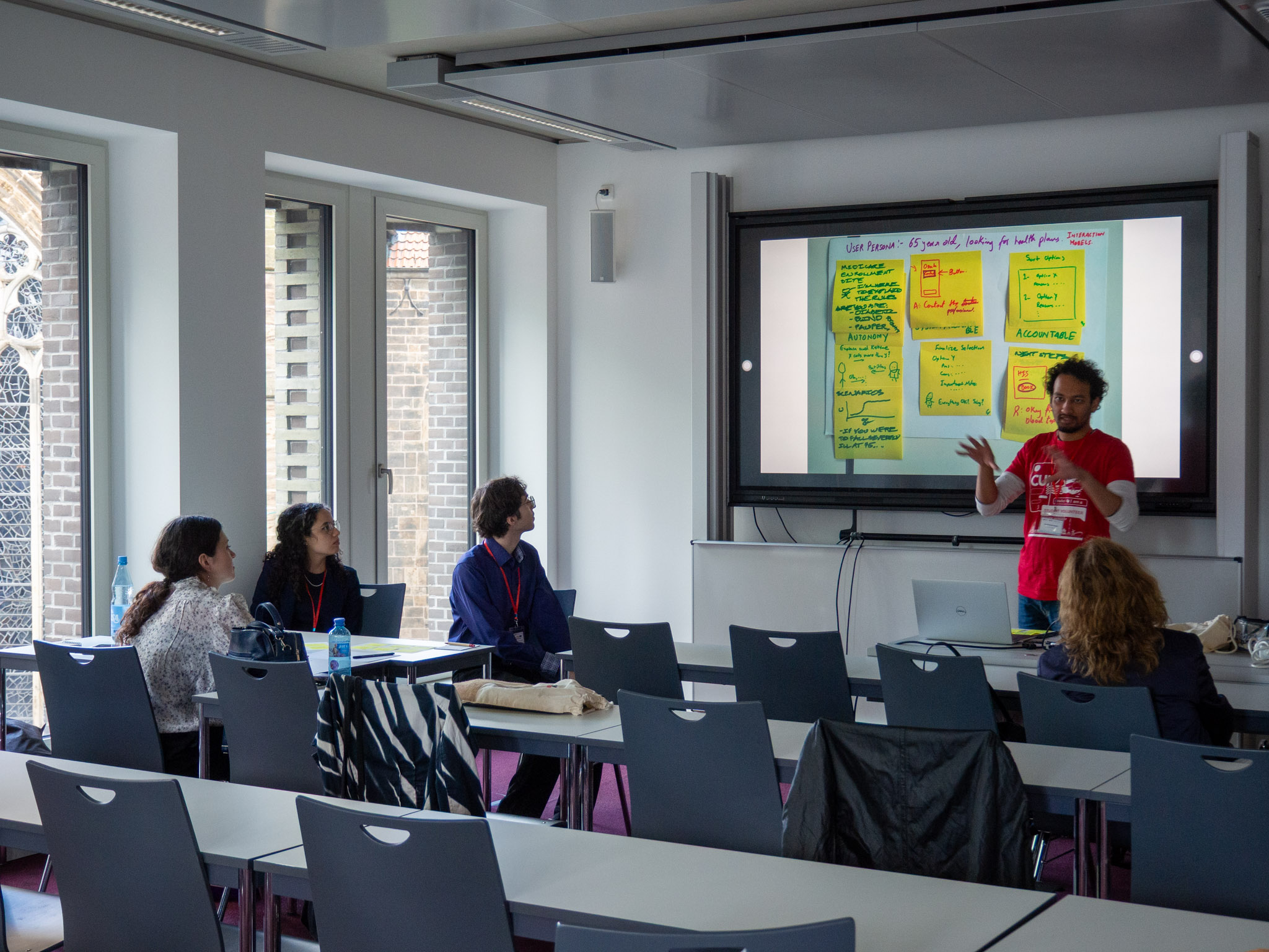 One of group 2 members presenting in front of the other participants.