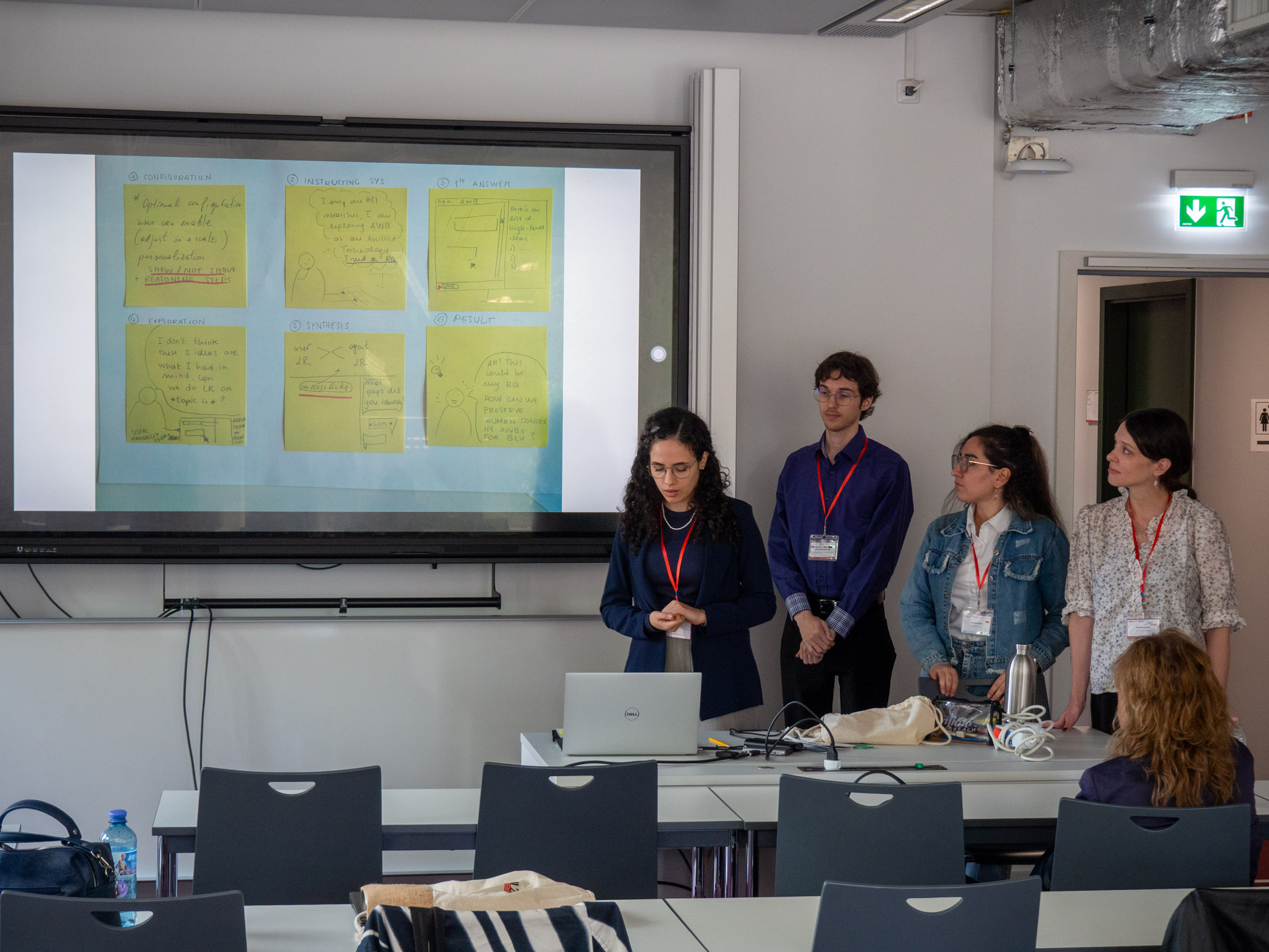 All members of group stand by the display while one of them presents their storyboard.